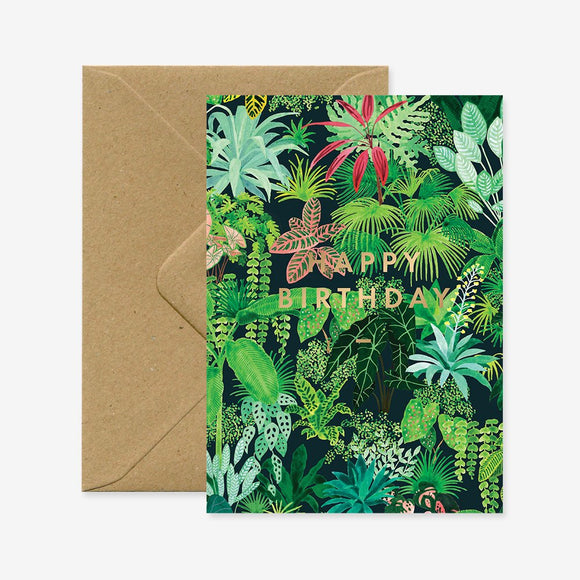 A birthday greeting card with a green plant design and 'Happy Birthday' text in gold, accompanied by a brown envelope.