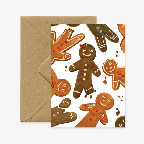 A Christmas greeting card with a design of gingerbread cookies, accompanied by a brown envelope.