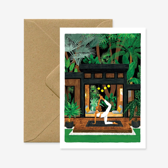 A greeting card depicting a person practicing yoga in a green, indoor setting with a brown envelope.