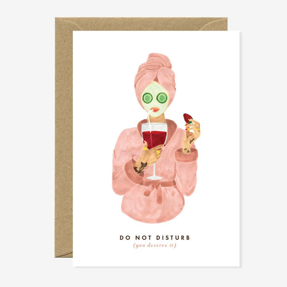 A greeting card with an illustration of a character holding a glass of wine, with gold foil details and the text 'DO NOT DISTURB (except maybe for wine)' on it.