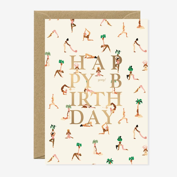 A birthday greeting card with a yoga pattern and the words 'HAPPY BIRTHDAY' in gold foil. It comes with a brown envelope.