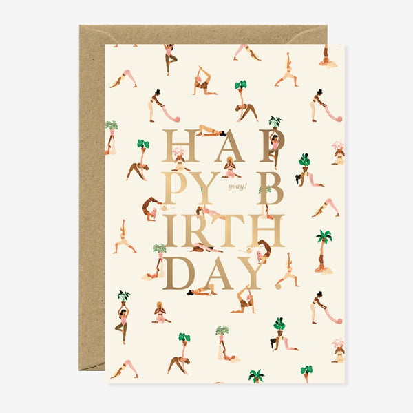 A birthday greeting card with a yoga pattern and the words 'HAPPY BIRTHDAY' in gold foil. It comes with a brown envelope.