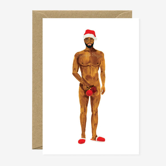 A Christmas themed greeting card with a gold foil illustration of a bearded man in a Santa hat, accompanied by a recycled brown envelope.