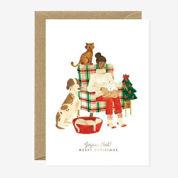 Illustrated Christmas greeting card depicting a family with pets, sending Christmas wishes, with gold foil details and a blank interior.