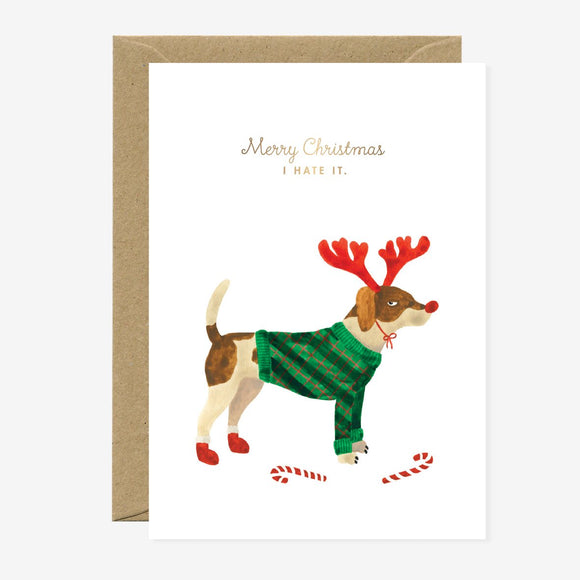 A Christmas greeting card with an illustration of a dog wearing a reindeer antlers hat and a green sweater. The text on the card reads 'Merry Christmas I made it.