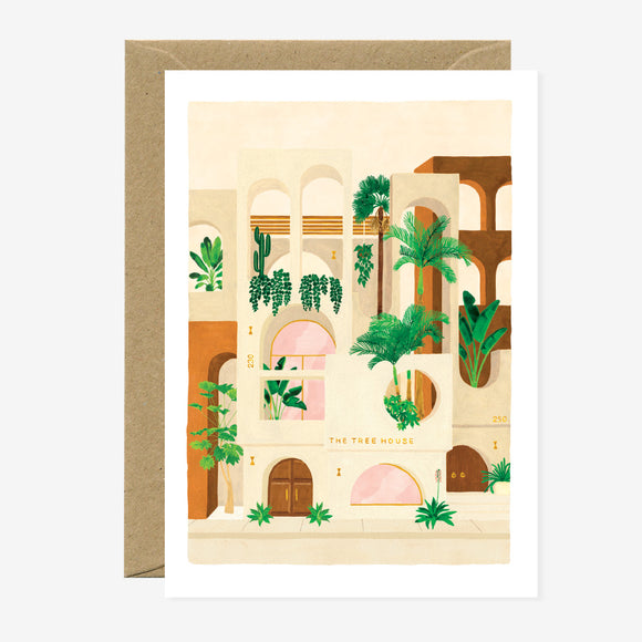 A greeting card featuring a illustration of a building with plants and geometric shapes, accompanied by a brown envelope.