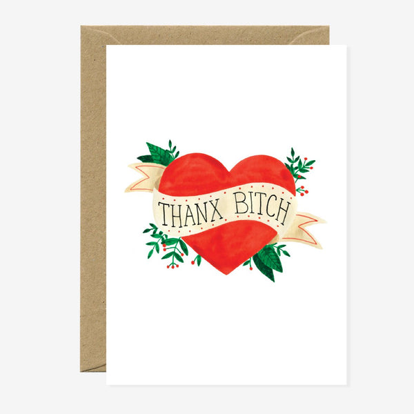 Greeting card with a bold red heart wrapped in a tattoo-style banner that reads “Thanx Bitch”, accented with green leaves and a playful vintage vibe.