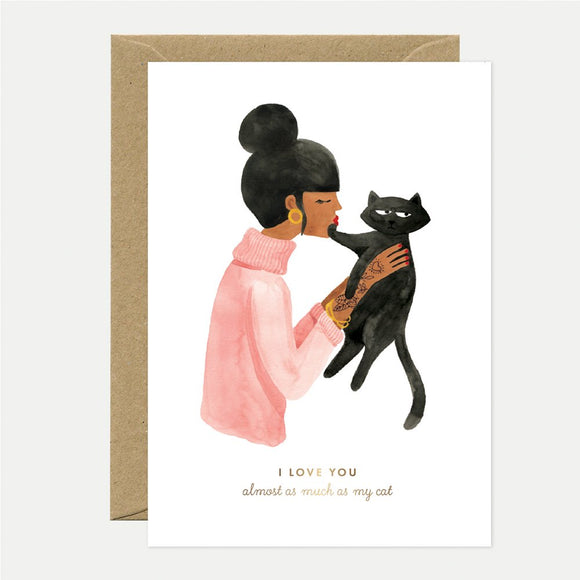 A greeting card with an illustration of a person hugging a black cat, with gold foil details and the text 'I love you almost as much as my cat'.