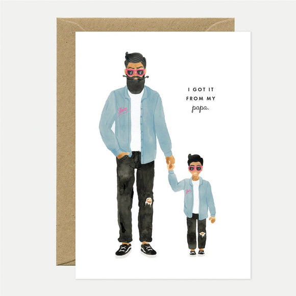 Illustrated greeting card depicting a father and son holding hands with the text 'I GOT IT FROM MY PAPA' on the upper part of the card. Both are dressed in similar outfits.
