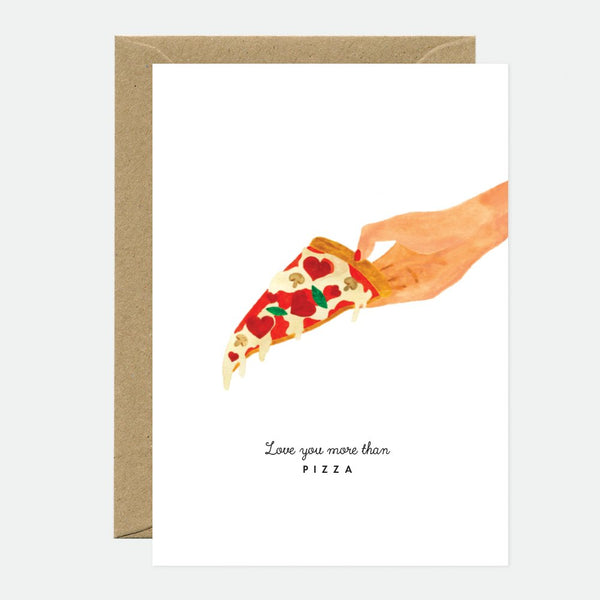 A greeting card with an illustration of a hand holding a slice of pizza with various toppings, accompanied by the phrase 'Love you more than PIZZA' printed at the bottom. A brown envelope is included.