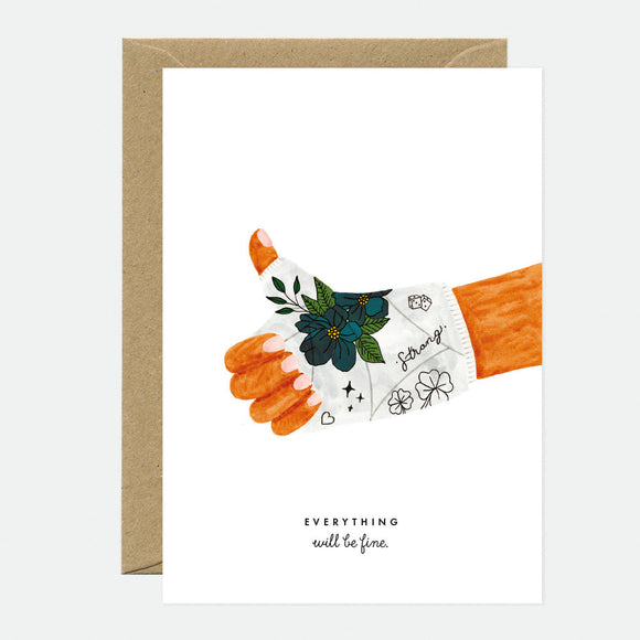 A greeting card with an illustration of a hand giving a thumbs up, with flowers and leaves on the hand, and the text 'EVERYTHING WILL BE FINE' on the front. A brown envelope is included.