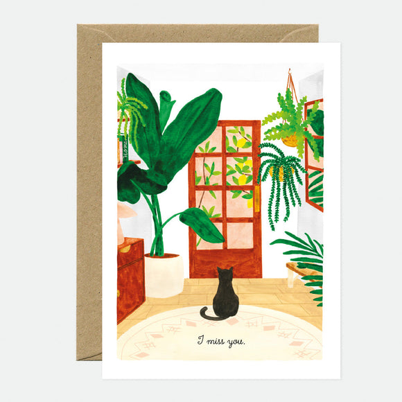 A greeting card with an illustration of a cat looking out of a window at plants outside, with the text 'I miss you' at the bottom.