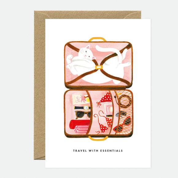 Greeting card with an illustration of a cat inside an open suitcase, surrounded by travel-related items like a map and sunglasses, with the text 'TRAVEL WITH ESSENTIALS' at the bottom.