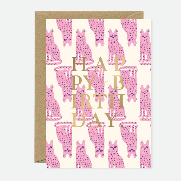 A greeting card with multiple pink cat illustrations and the words 'HAPPY BIRTHDAY' in gold foil.