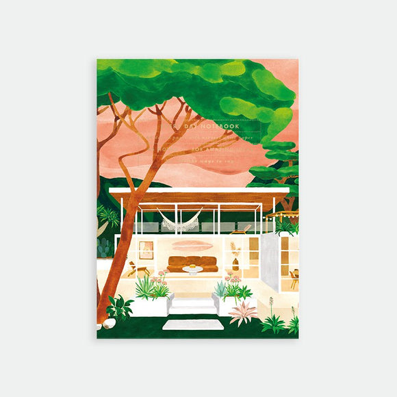 A5 notebook with a tropical modern house illustration, featuring lush plants, warm sunset sky, and gold foil details on the cover.