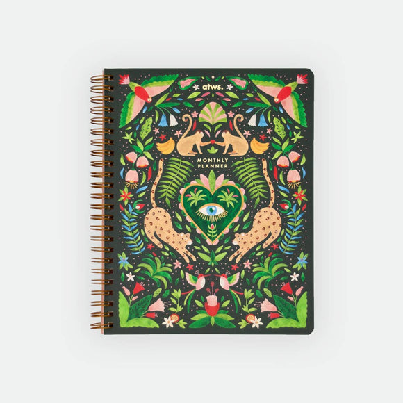 A spiral monthly planner with a vibrant green jungle design, featuring gold foil cover and colorful illustrations of plants and animals.