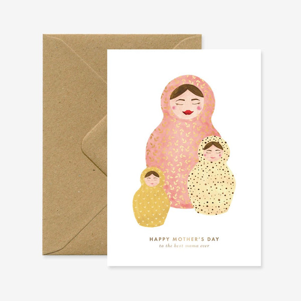 A Mother's Day greeting card with a illustration of a matryoshka doll and the text 'Happy Mother's Day' on it, accompanied by a brown envelope.