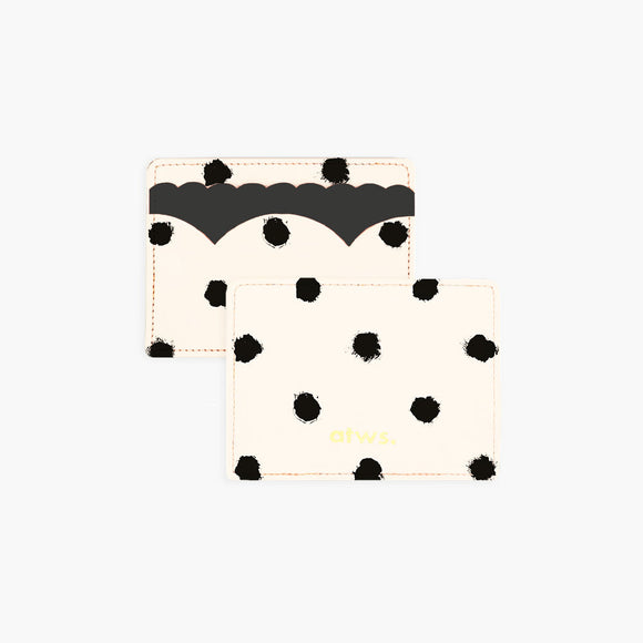 A beige card holder with black painted dots and scalloped edges, displaying the text 'Dior'.