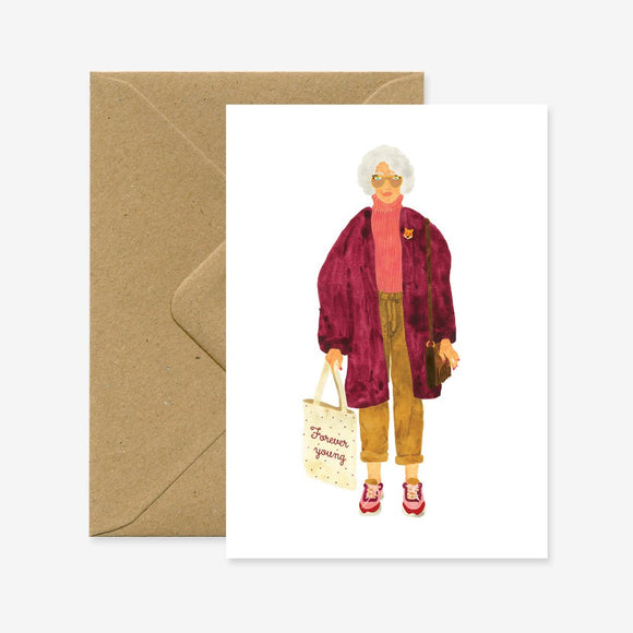 A greeting card featuring an illustration of an older woman wearing a purple coat and holding a shopping bag, accompanied by a brown envelope.