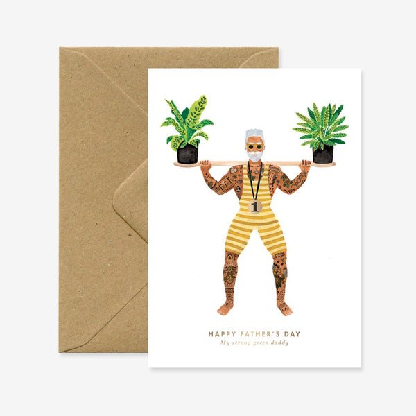 Greeting card with an illustrated tattooed weightlifter dad in a yellow striped outfit lifting two potted plants, with the text “Happy Father’s Day”.