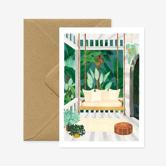 A greeting card depicting a illustration of an outdoor seating area with plants and a brown envelope.