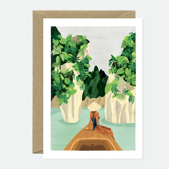 Greeting card with an illustration of a natural scene, featuring a body of water with green plants and a person in a boat. The card has a blank interior and comes with a brown envelope.