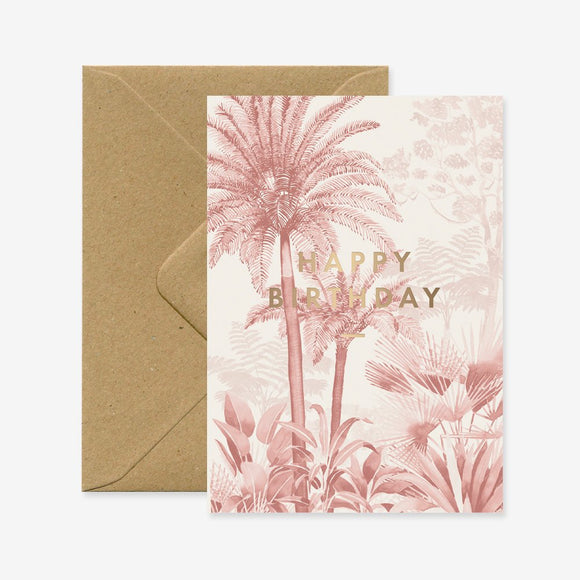 A birthday greeting card with a floral pattern and 'Happy Birthday' text in gold, accompanied by a brown envelope.