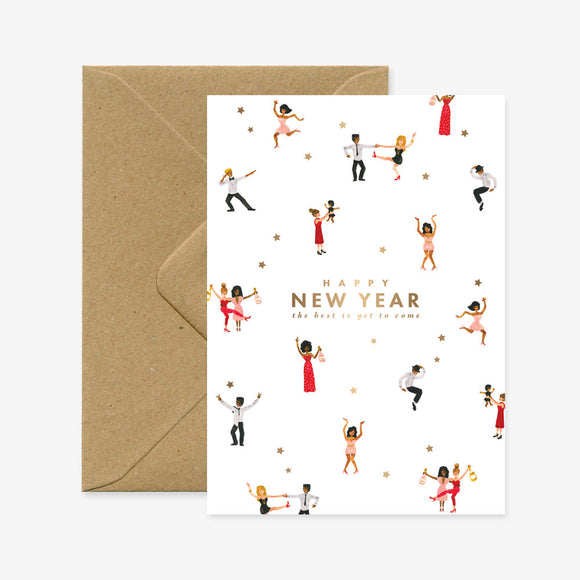 A New Year greeting card with multiple illustrations of people dancing and a gold foil text that reads 'HAPPY NEW YEAR'. The card is accompanied by a brown envelope.