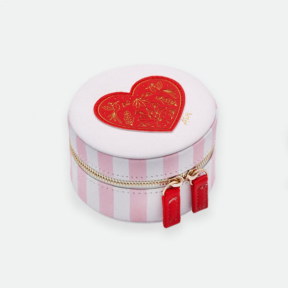 A pink striped jewellery box with a red heart-shaped lid, featuring a cotton-lined interior and a small chain for portability.