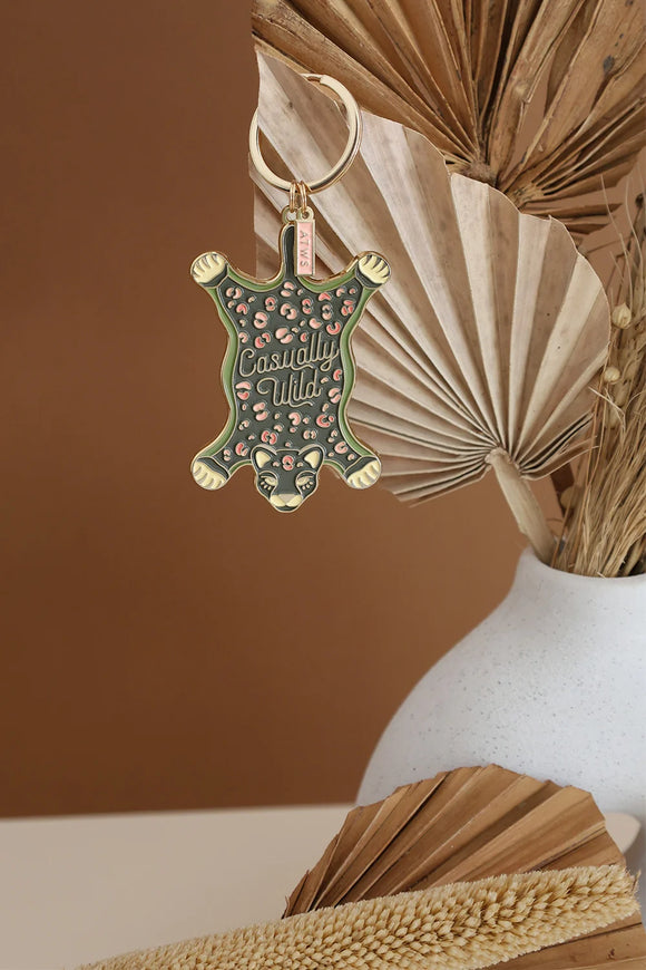 Leopard rug shaped keychain with green and pink details and gold metallic finish