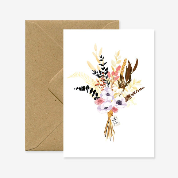 A floral greeting card with a variety of flowers and foliage, accompanied by a brown envelope.