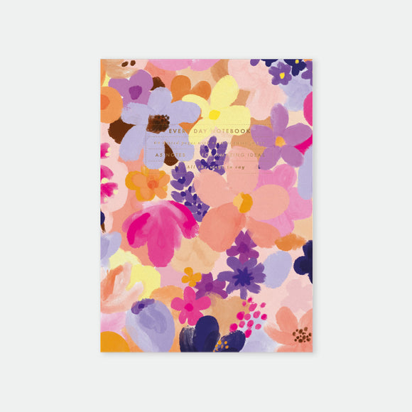A5-sized notebook with a floral pattern and gold foil details on a pink background.