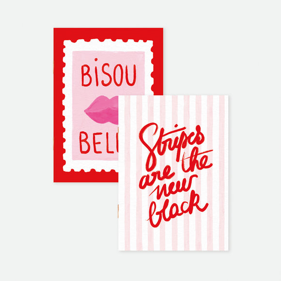 Set of two A6 pocket notebooks, one with red “Bisou Bella” stamp and pink lips, the other with pink stripes and red lettering, gold foil details.