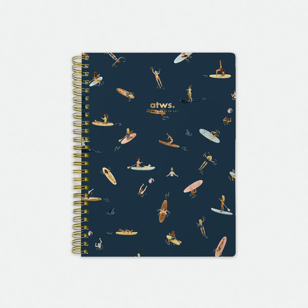 Paddle Girls Spiral Notebook – navy blue cover with playful paddleboarding and surfing illustrations, gold foil details, by All the Ways to Say.