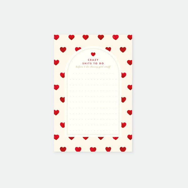 A notepad with a white background and a border of red hearts. The notepad has text at the top which seems to be a brand or product name.