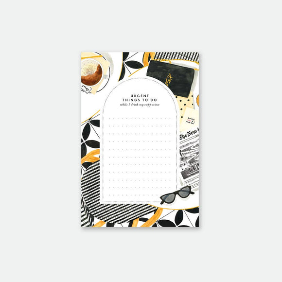 A multicolor floral-patterned notepad with a black and white grid design and text '50 pages' on the cover.