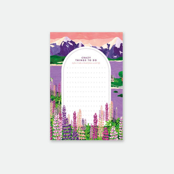 A colorful notepad with a floral design and mountains in the background, titled 'Crazy Things to Do'.