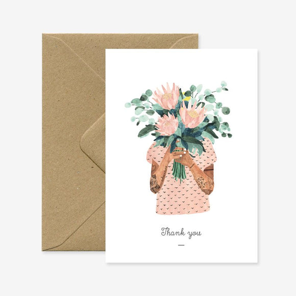 A thank you greeting card with a floral illustration and a brown envelope.