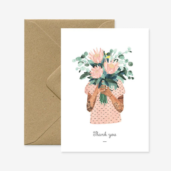 A thank you greeting card with a floral illustration and a brown envelope.