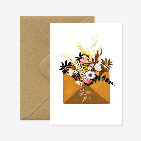 A thank you greeting card with a floral envelope design, accompanied by a brown envelope.