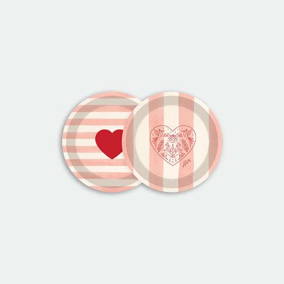 Round coaster tray with pink striped background featuring red heart and floral heart illustrations, made of birch wood
