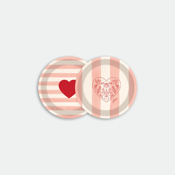 Round coaster tray with pink striped background featuring red heart and floral heart illustrations, made of birch wood