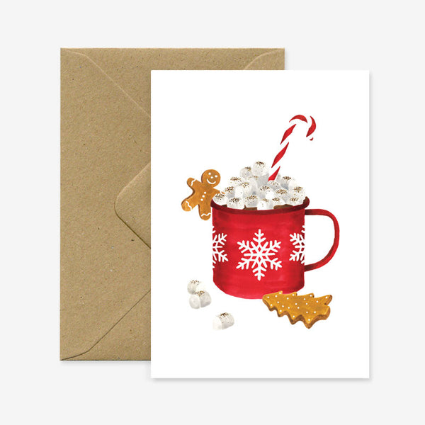A Christmas themed greeting card with a illustration of a red mug filled with hot chocolate, marshmallows, and a candy cane, accompanied by gingerbread cookies and snowflake decorations.
