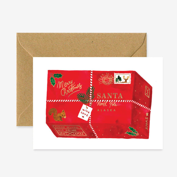 A red Christmas themed greeting card with gold foil details and a brown envelope.