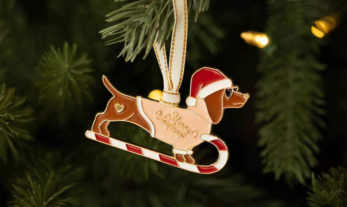 All the Ways to Say Christmas ornaments – pink nutcracker enamel decoration hanging on a tree