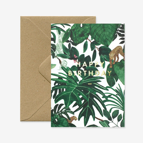Greeting card with tropical jungle leaves, gold foil "Happy Birthday" text, and small leopards hidden among the foliage.