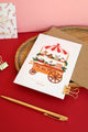 Sweet Little Christmas card by All The Ways To Say – festive illustrated card with gingerbread cart on red and pink background