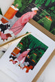 Colorful notebook and greeting card set with dog illustrations and green botanical background, styled with coffee and gold pen — All the Ways to Say stationery.
