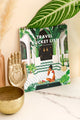 Close-up of Travel Bucket List 2026 calendar cover – woman eating watermelon in green riad courtyard