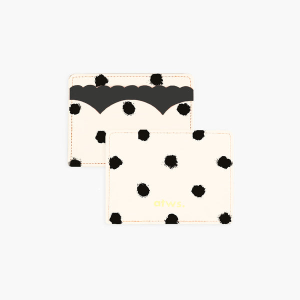 A beige card holder with black painted dots and scalloped edges, displaying the text 'Dior'.